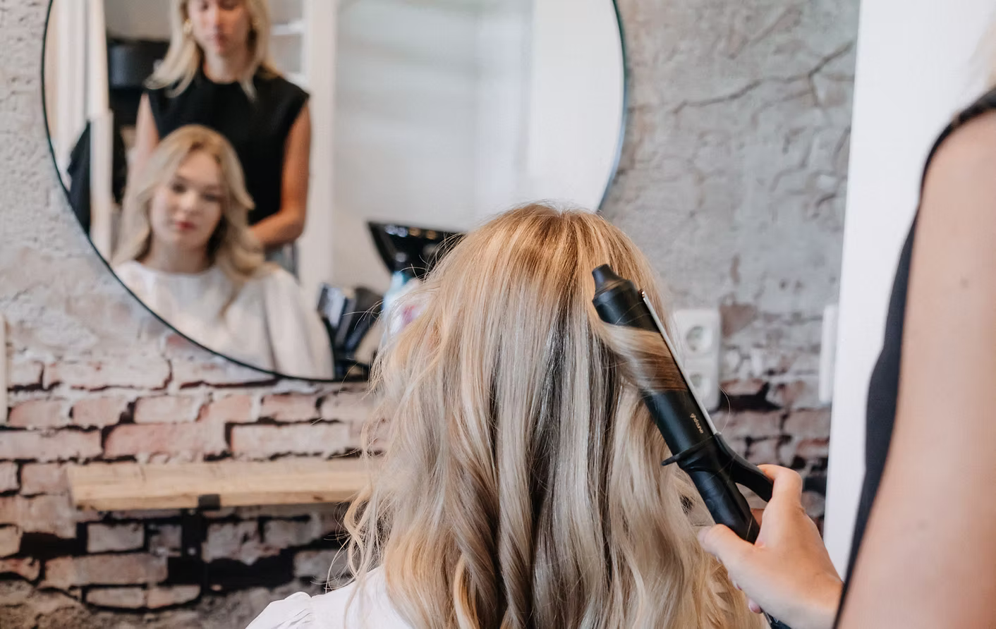 Mooi blond haar wordt gestyled in de salon van Favoriev